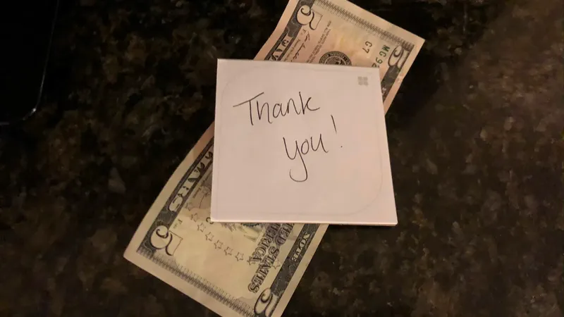 Cash tip with thank you note